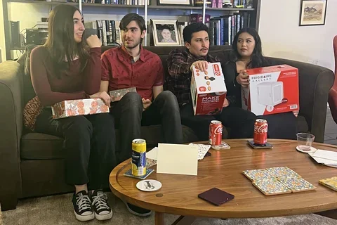 four people sitting on a couch