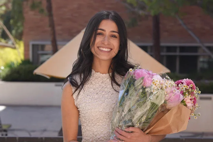 Woman standing with a bunch of flowers