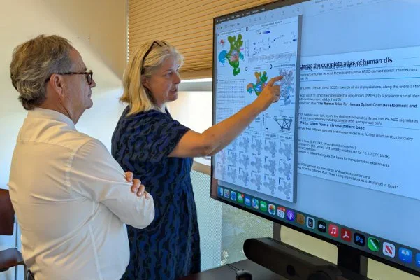 A man and woman looking at scientific data