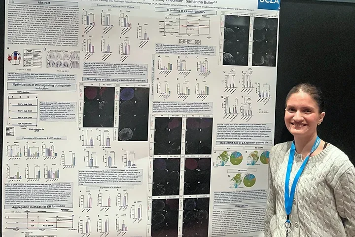 Woman presenting a poster at a scientific meeting