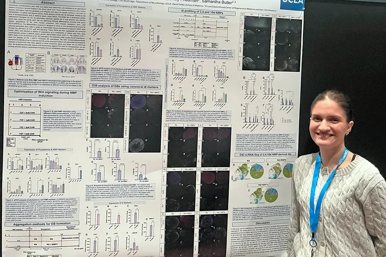 Woman presenting a poster at a scientific meeting