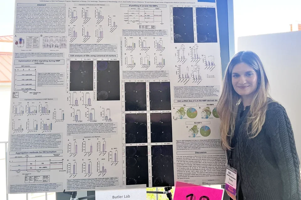 Smiling woman presenting a scientific poster at a meeting