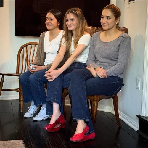 Three women watching presents being opened