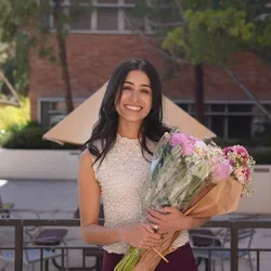 Woman standing with a bunch of flowers