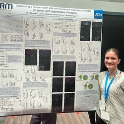 Woman presenting a poster at a scientific meeting